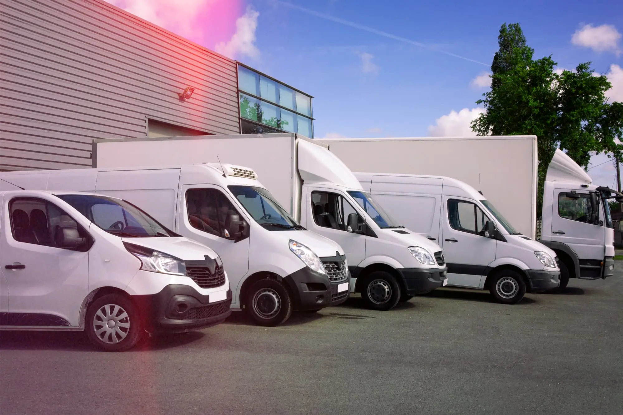 Fleet of white vans parked in a row showing diverse van tracking solutions